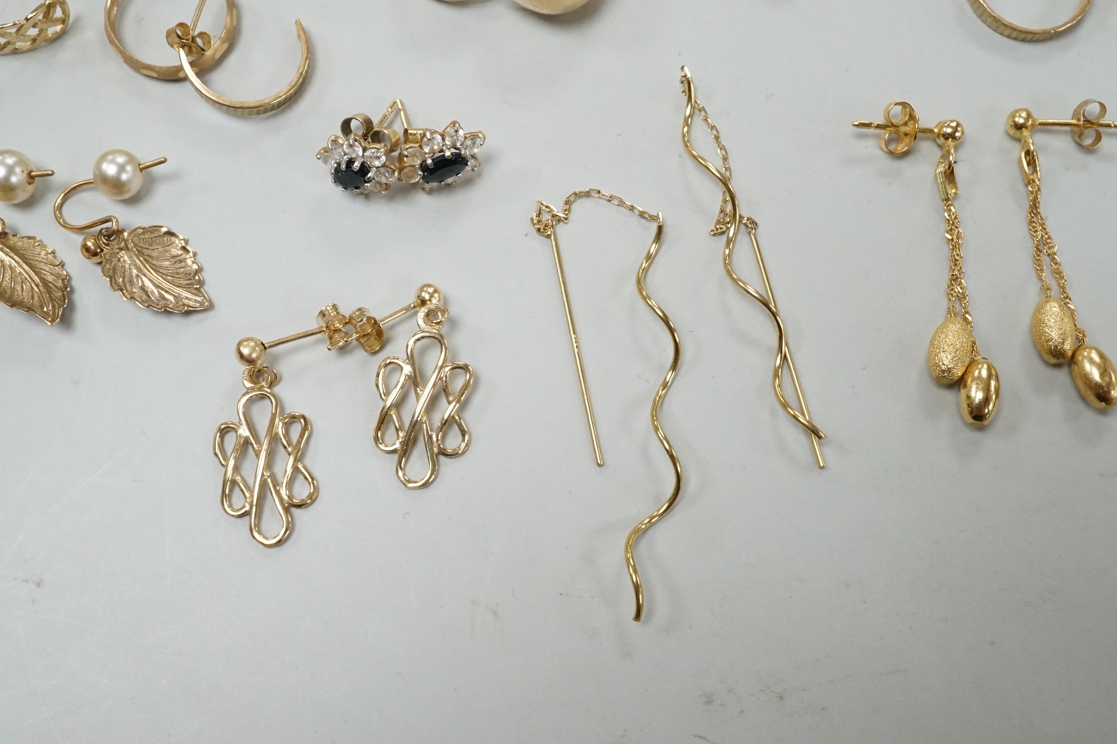 Seven assorted modern pairs of 9ct earrings including tassel drop and pear shaped, 12.7 grams and ten other yellow metal pairs, three odd ear studs and a small heart pendant?